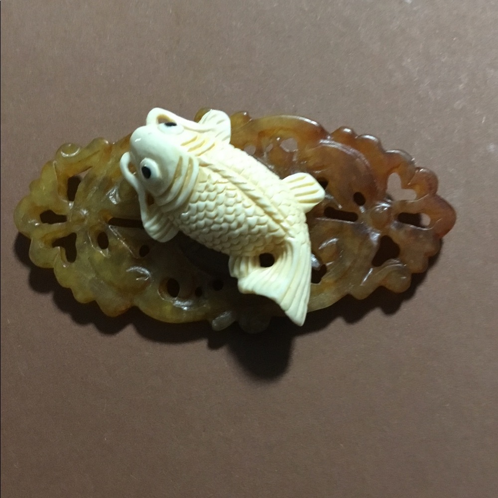 Carved lily pad with cream colored fish